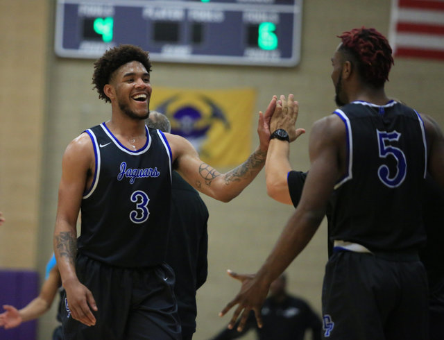 Desert Pines senior Trevon Abdullah (3) smiles as he is pulled off the court in the fourth q ...