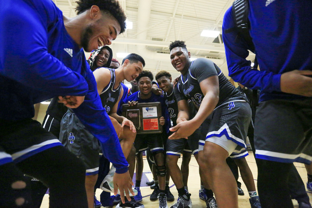 The Desert Pines High School Jaguars dance with a regional trophy after beating Cheyenne Hig ...