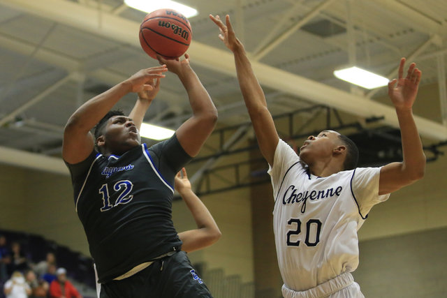 Desert Pines senior Jalen Graves (12) takes a shot during the Class 3A boys regional basketb ...