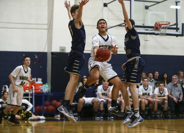 Lake Mead’s Kai Madela (5) goes up to score between Rancho Solano’s Hunter Ruck ...