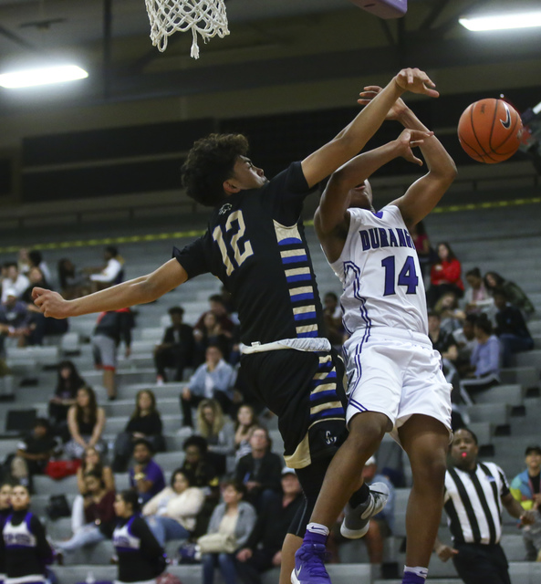 Sierra Vista forward Maui SeraJosef (12) blocks a shot from Durango guard Juwan Rohan (14) d ...