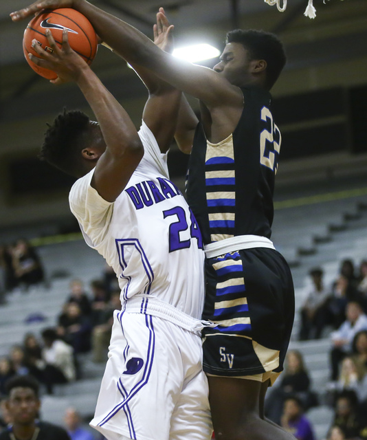 Sierra Vista forward Lerone Gibson (22) blocks a shot from Durango forward Zyare Ruffin (24) ...