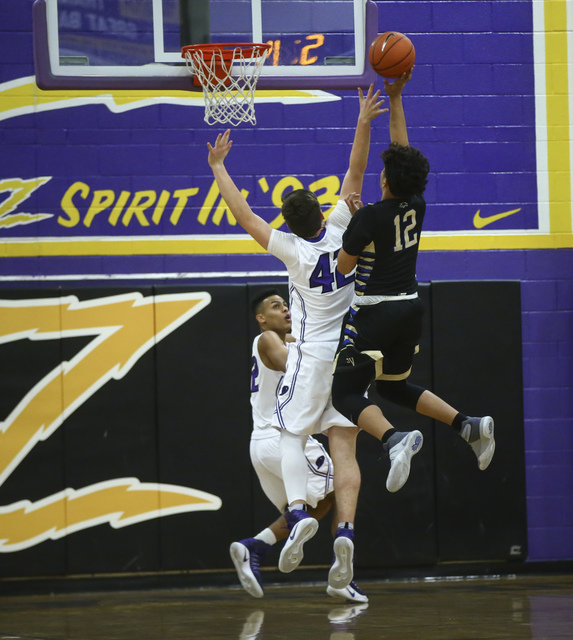 Sierra Vista forward Maui SeraJosef (12) sends up a shot over Durango forward Jovan Lubura ( ...