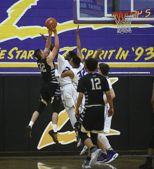 Sierra Vista guard Maka Ellis (32) sends up a shot over Durango defense during a basketball ...