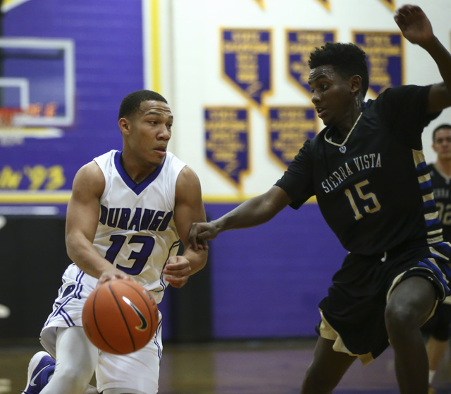 Durango guard Demetrius Valdez (13) drives against Sierra Vista guard Zekarias Kassaye (15) ...