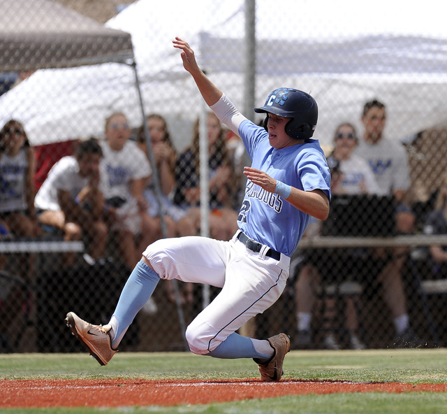 Centennial outfielder Ricky Koplow scores the first run of the game against the Bishop Gorma ...