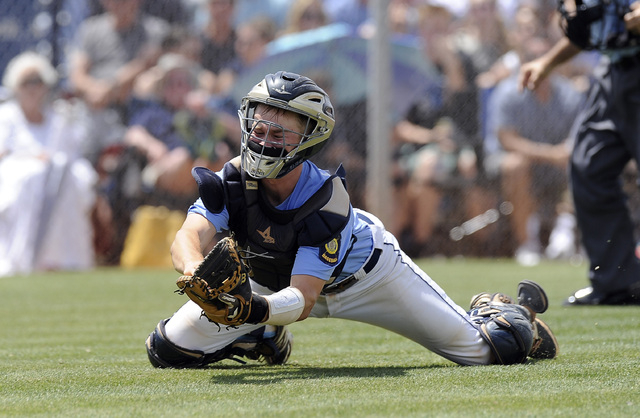 Centennial catcher Hayden Grant makes a diving catch in foul territory to retire Bishop Gorm ...