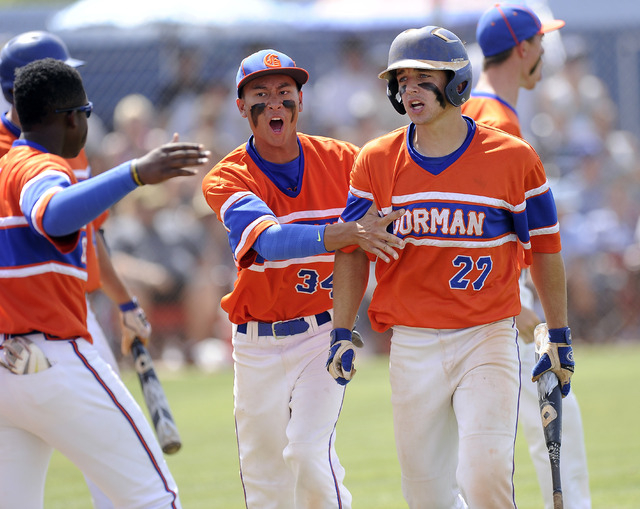 Bishop Gorman’s Grant Robbins (27) is congratulated by teammates after scoring a run i ...