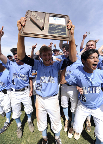 Centennial pitcher Cooper Powell holds up the Sunset Region championship trophy as the rest ...