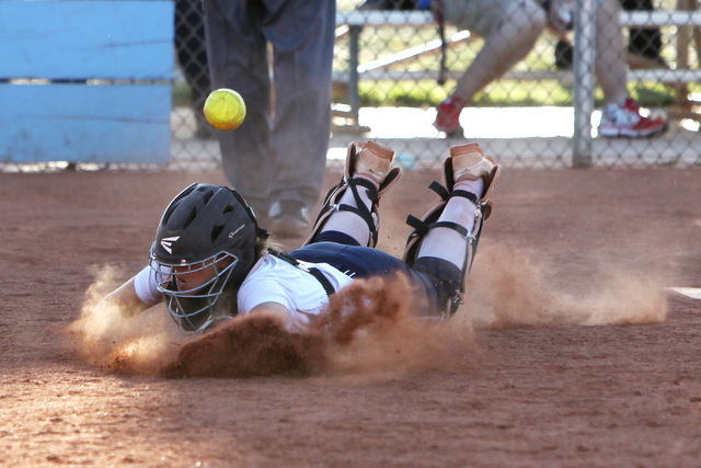 Centennial catcher Makenzie Ball dives for a foul ball during their softball game against Sh ...