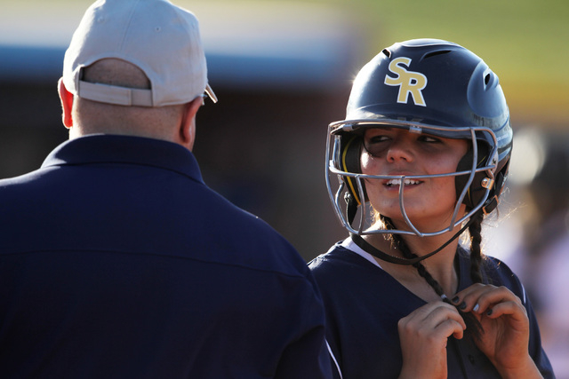 Shadow Ridge’s Justin Garganese talks with her first base coach during their softball ...