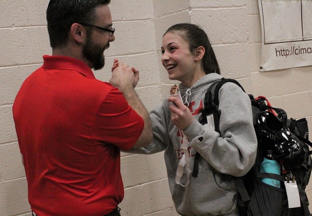 Arbor View’s Peyton Prussin shows off her third-place medal to coach Tyler Sutton, as ...