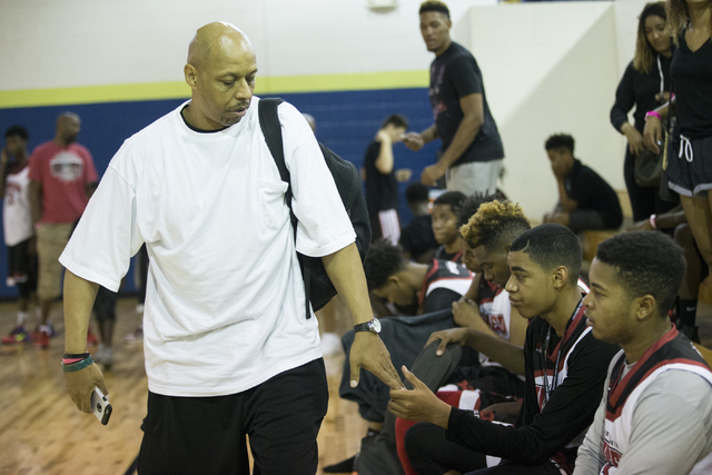 Lee Strawther shakes hands with his son Julian after winning his game during a Bigfoot Hoops ...