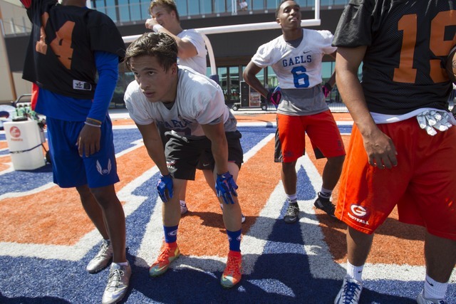 Bishop Gorman football players, including running back Baggio Ali Walsh, second left, (7) wa ...