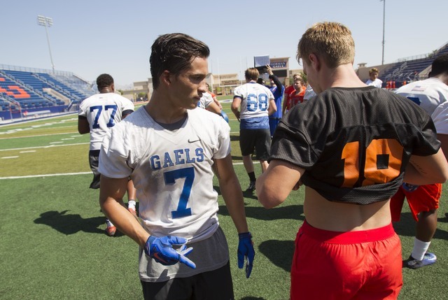 Bishop Gorman running back Baggio Ali Walsh, left, (7) walks past a teammate during team pra ...