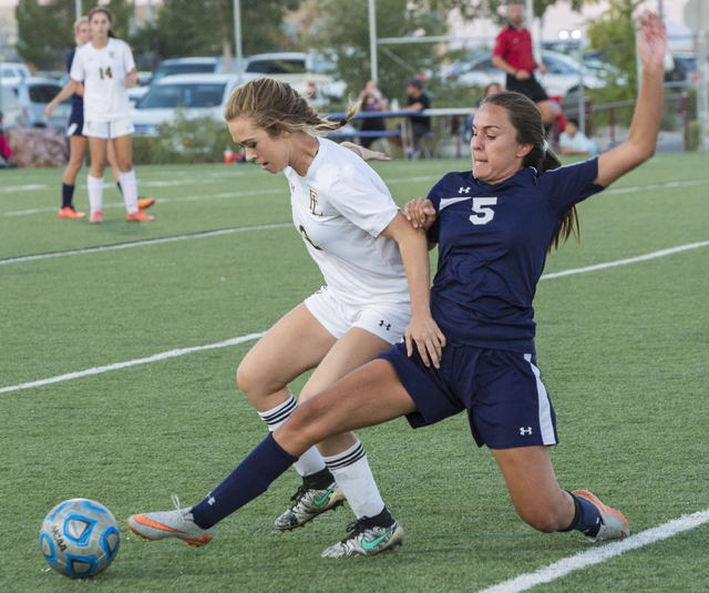 Centennial’s Cameron Sickels (5) slide tackles Faith Lutheran’s Megan Sonerholm ...