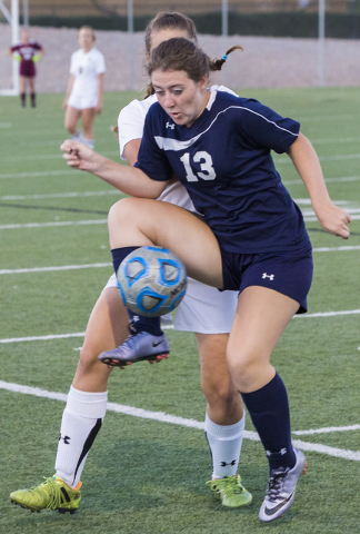 Centennial’s Shannon Hutchins (13) fights for a loose ball with a Faith Lutheran defen ...