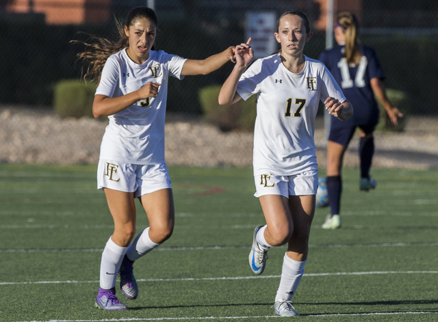 Faith Lutheran’s Maggie Shuirman (17) celebrates with teammate Isabella Gutierrez (3) ...