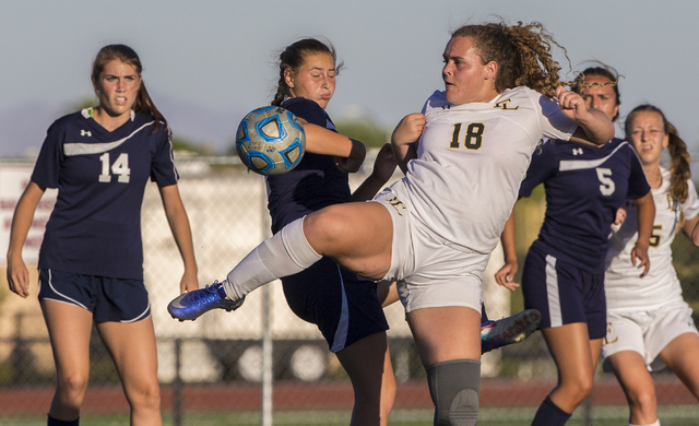 Faith Lutheran’s Brooke Nigro (18) fights for a ball with Centennial defenders at Fait ...