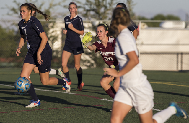 Faith Lutheran’s Beka Lescenski (00) clears a ball from the box during her team’ ...