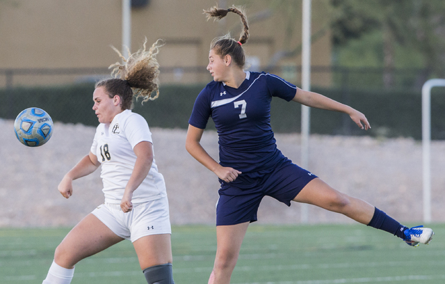 Centennial’s Lauren Levoyer (7) goes up for a header with Faith Lutheran’s Broo ...