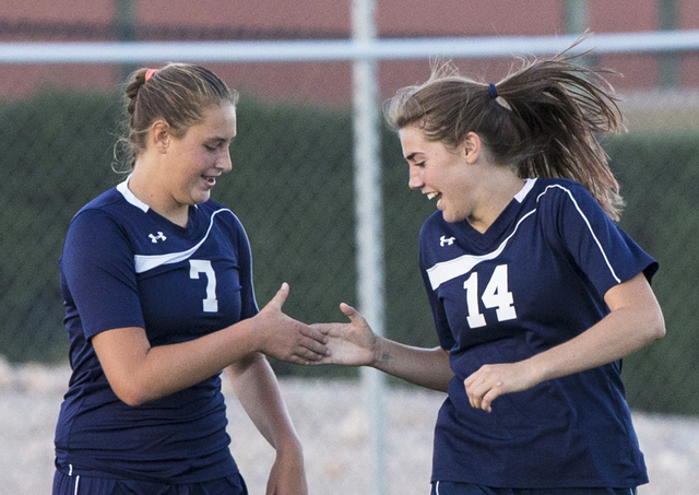 Centennial’s Lauren Levoyer (7) and McKenna Stratton (14) celebrate a second half goal ...