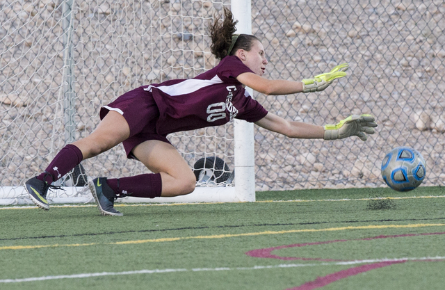 Faith Lutheran’s Beka Lescenski (00) makes a diving stop during her team’s home ...