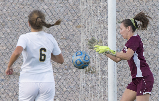 Faith Lutheran’s Beka Lescenski (00) grabs a loose ball during her team’s home m ...