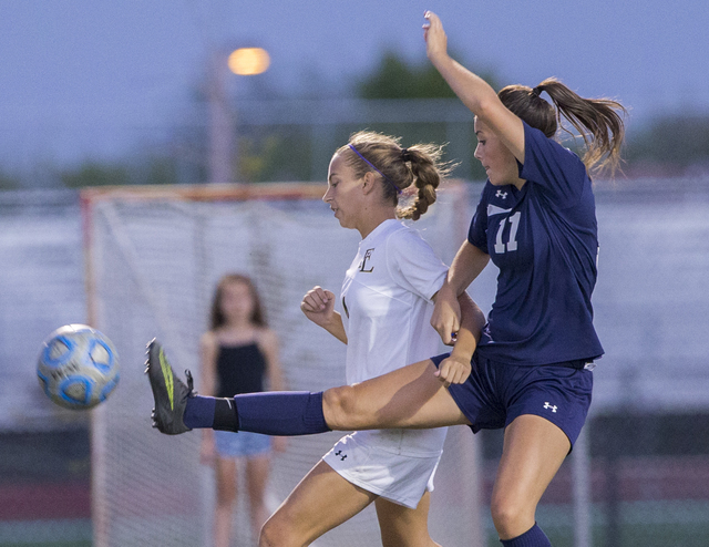 Centennial’s Amanda Page (11) fights for a ball with Faith Lutheran’s Megan Sone ...