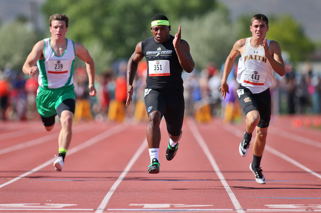 Desert Pines’ Eric Wilkes, center, wins the Division I-A boys 100-meter dash with a ti ...