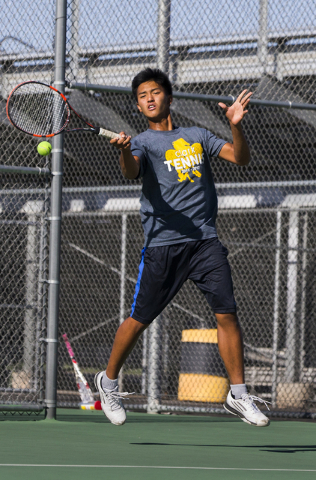 Clark High School’s Marcus Pasimio hits a forehand return during a home tennis meet ag ...