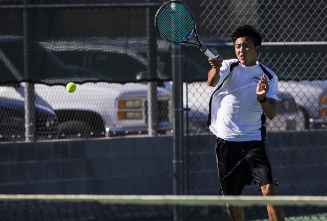 Clark High School’s Michael Pasimio hits a forehand return during a home tennis meet a ...