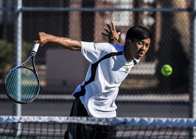 Clark High School’s Michael Pasimio hits a backhand return at the net during a home te ...