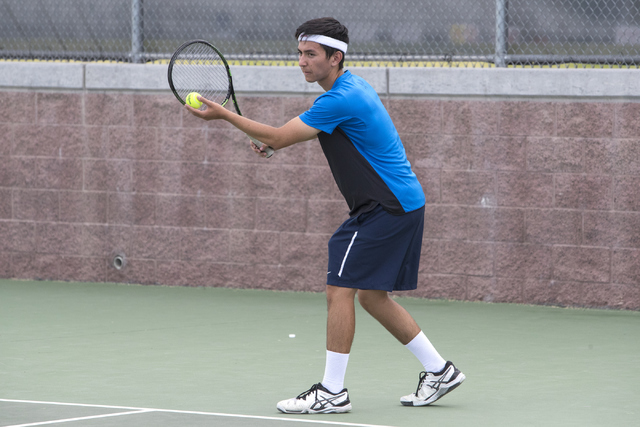 Wesley Harris from Coronado High School prepares to serve the ball during a tennis match at ...