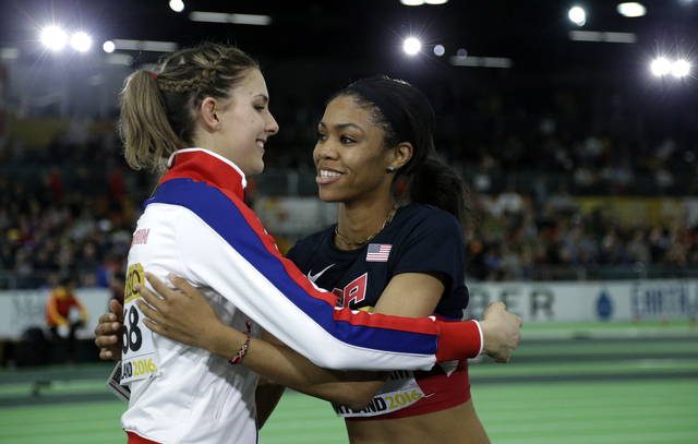 United States’ Vashti Cunningham, right, is hugged by Britain’s Isobel Pooley af ...