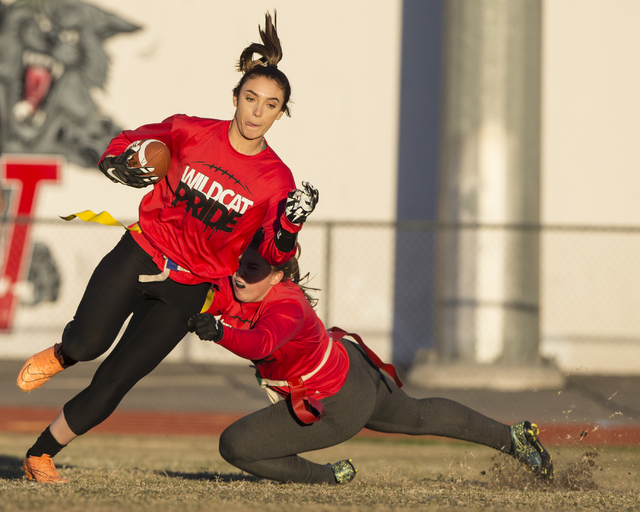 Wildcat wide receiver Natalie Gennuso, left, runs for extra yardage after a catch during fla ...