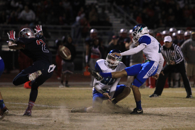 Liberty defensive back Ethan Dedeaux nearly gets his hands on Green Valley kicker rank Canal ...