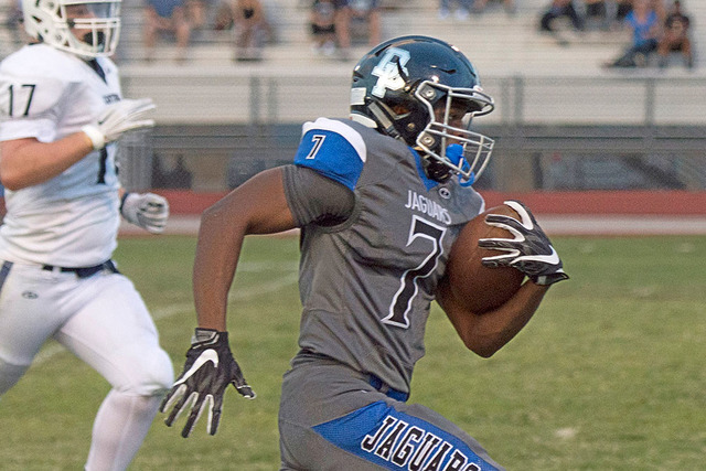 Desert Pines High School’s Isaiah Morris (7) runs the ball upfield to score a touchdow ...