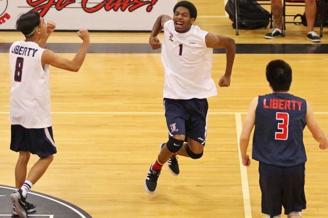 Liberty’s Jerry Ward, center, celebrates after making the last play in Game 2 against ...