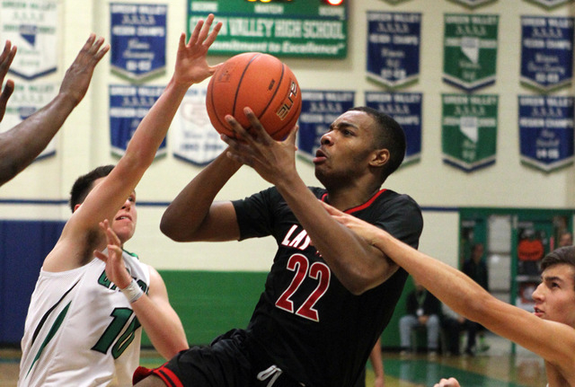 Las Vegas shooting guard Patrick Savoy (22) looks to shoot between Green Valley’s Bran ...