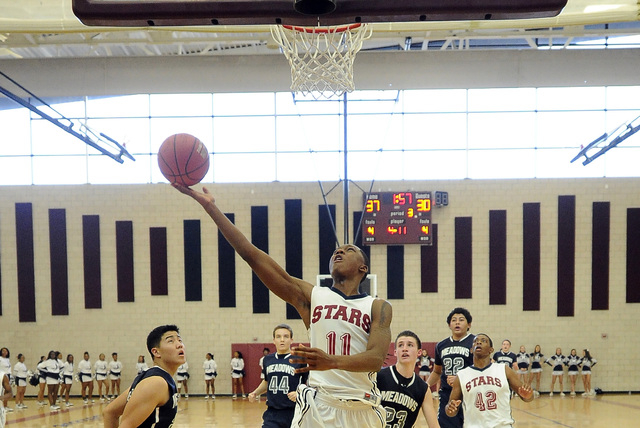 Agassi Prep guard Deishuan Booker (11) goes up for a layup against The Meadows on Saturday. ...