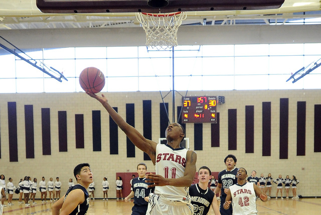 Agassi Prep guard Deishuan Booker (11) goes up for a layup against The Meadows earlier this ...