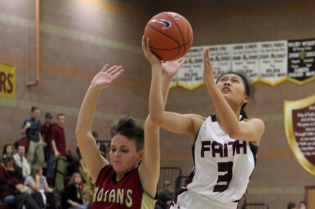 Faith Lutheran’s Maddie Bocobo (3) shoots past Pahrump’s Amber Skilling (21) dur ...