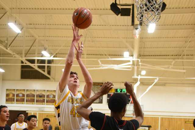 Bonanza forward John Holden (42) shoots the ball over Desert Oasis forward Aamondae Coleman ...