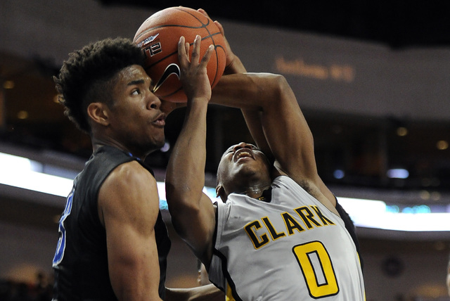 Clark guard Colby Jackson is fouled by Desert Pines point guard Coby Myles as Trevon Abdulla ...