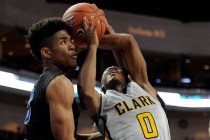 Clark guard Colby Jackson is fouled by Desert Pines point guard Coby Myles as Trevon Abdulla ...