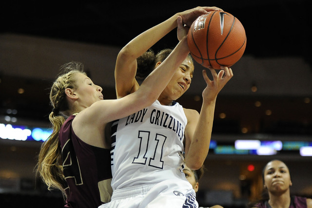 Spring Valley guard Kayla Harris (11) grabs a defensive rebound against Faith Lutheran forwa ...