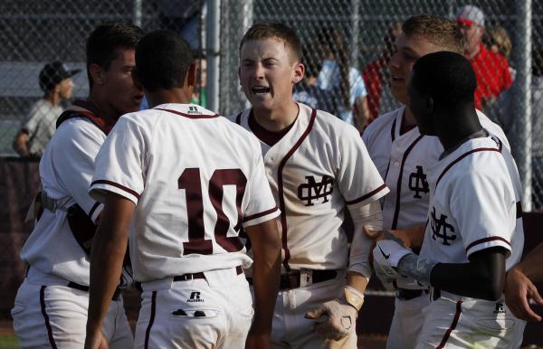 Cimarron-Memorial’s Nick Borowski, center, celebrates after hitting a game-winning hom ...