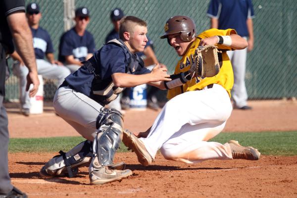 Brett Doyle slides past Centennial catcher Noah Given to score on Dave Estrada’s fifth-inn ...