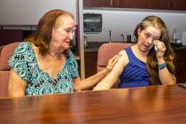 Joan Miller, left, the longest-tenured volunteer with the Trauma Intervention Program, consoles ...